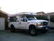2000 Ford F-250 - This pickup truck is equipped with a camper shell, extending its utility for travel and outdoor activities.