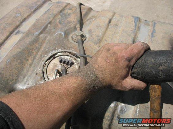 Fuel tank with hand holding pipe wrench
