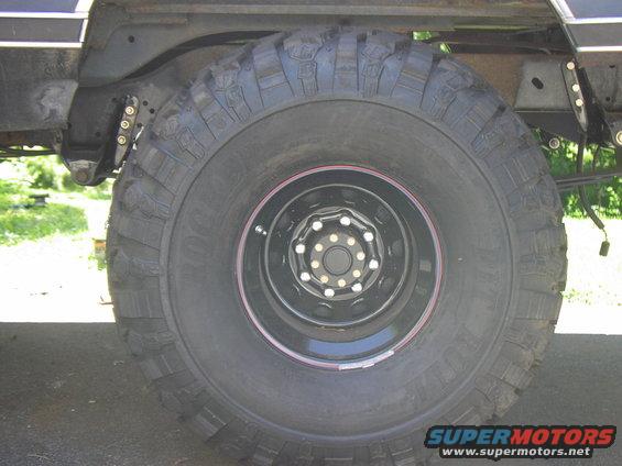 Tire and suspension components of a large vehicle, possibly a truck or SUV
