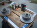 1971 Ford Torino - Brake rotors and cleaning supplies are laid out on a wooden pallet for a car maintenance task.