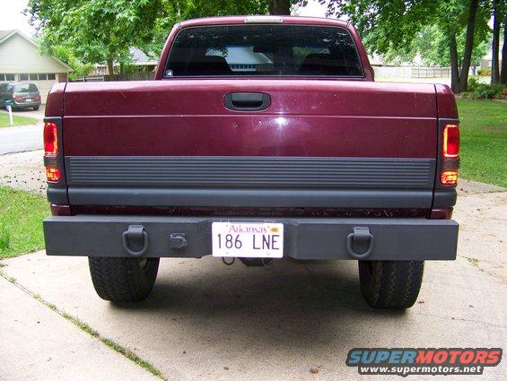 Maroon 2001 Dodge 1500 rear view with aftermarket bumper and tow hooks