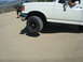1986 Ford Bronco - White pickup truck with a person in the driver's seat, another vehicle in the background.