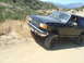 1986 Ford Bronco - This black 1986 Ford Bronco is seen off-road on a sunny day.