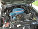 1971 Ford Torino - The engine bay of a 1971 Ford Torino is pictured, its V8 engine and associated components.