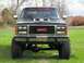 1991 GMC Jimmy - This lifted 1991 GMC Jimmy features a prominent GMC grille and a "Brown's Tire & Auto" banner across the windshield.