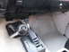 1991 GMC Jimmy - The interior of a vehicle displays a manual transmission shifter and floor mats.