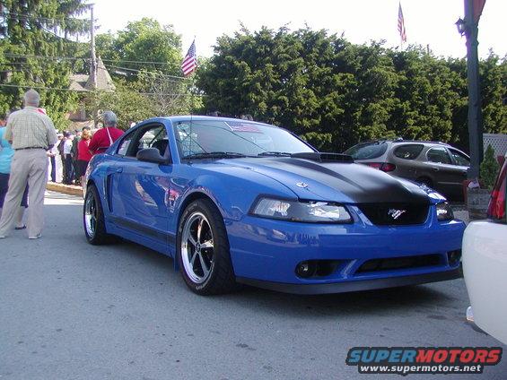 Blue 2004 Ford Mustang with black hood stripes and racing wheels