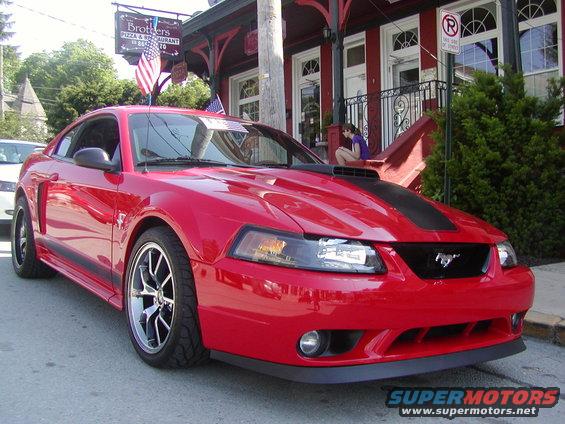 Red 2004 Ford Mustang parked on street, front quarter view