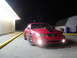 2004 Ford Mustang - Red 2004 Ford Mustang with black racing stripes parked outside at night.