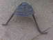 1995 Ford Bronco - This metal bracket has two legs, one of which ends in a flat foot.
