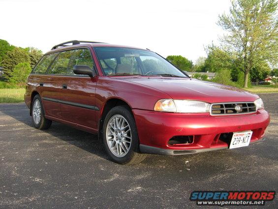 Red 1998 Subaru Legacy station wagon, front 3/4 view, parked on asphalt