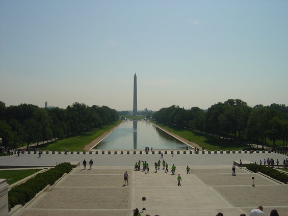 Washington Monument and Reflecting Pool with people walking around