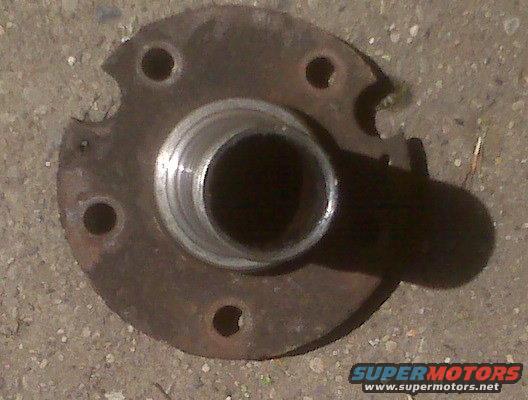 rusted wheel hub with five bolt holes and a central bearing race
