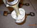 1995 Ford Taurus - Engine components, specifically pistons and connecting rods, are displayed on a speckled gray surface.