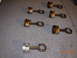 1995 Ford Taurus - Several engine pistons and connecting rods are laid out on a garage floor.
