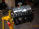 1995 Ford Taurus - Engine assembly mounted on a yellow stand, with visible crankshaft and oil pan details.