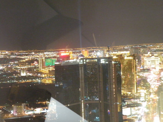 Las Vegas Strip skyline at night with illuminated buildings and a beam of light