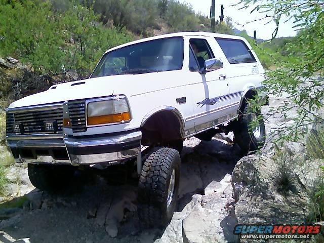 White 1996 Ford Bronco navigating rocky terrain