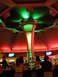 1989 Nissan 300ZX - The interior of a bar is illuminated by dramatic red and green lighting, with patrons seated at the bar.
