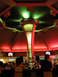1989 Nissan 300ZX - People sit at a bar in a casino, illuminated by red and green lights.