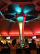 1989 Nissan 300ZX - The interior of a bar features a central pillar illuminated with blue and green lights, surrounded by red lighting on the ceiling.