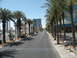 1989 Nissan 300ZX - A street scene on the Las Vegas Strip, lined with palm trees and tall buildings under a clear blue sky.