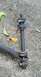 1976 Ford Ranchero - A suspension linkage part is shown in detail, resting on a concrete surface.