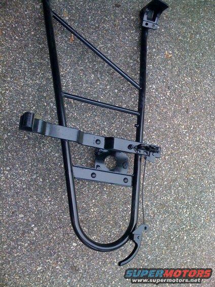 Black metal spare tire carrier with mounting bracket and latch mechanism