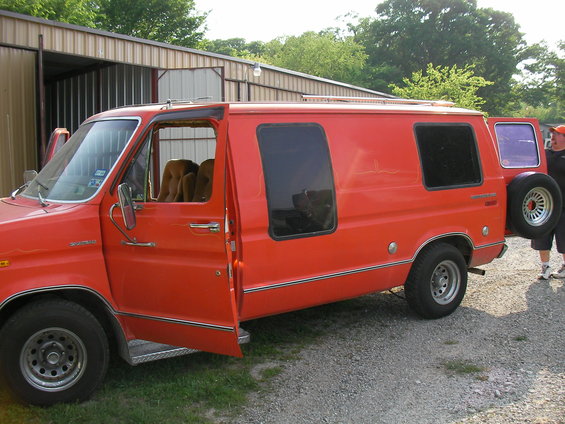 1978 Ford E150 van, orange, driver's door and rear door open, spare tire mounted on rear door