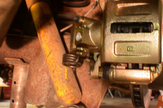 dscn3873.jpg Another bracket is needed to properly position the emergency brake connection on the caliper. Right now, without the bracket, the rear shocks interferes with it.