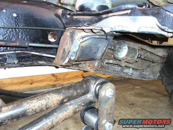 Underbody view of truck frame with fuel filter and suspension components