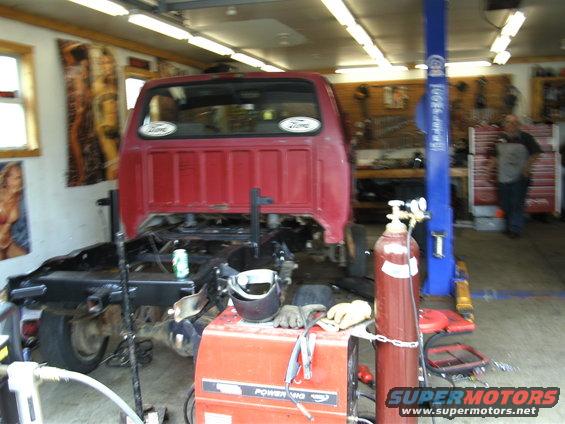 1994 Ford F-250 chassis in a garage with welding equipment