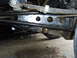 1994 Ford F-250 - A close-up view of a truck's undercarriage reveals its suspension components, including leaf springs and the rear differential. The "SUPERM…