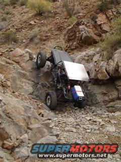 Off-road buggy climbing steep rocky terrain
