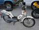 2002 Kawasaki Ninja - A white moped with "bravo" text on its side panel is parked next to other vehicles.