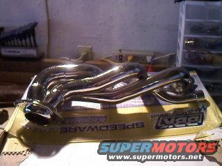 Chrome exhaust headers on a box labeled BBK Performance