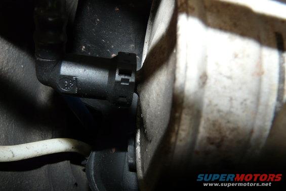 close-up of a black plastic fuel line connector attached to a metal component