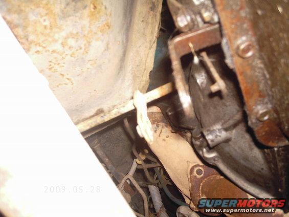 Underside view of vehicle exhaust pipe and transmission components