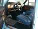 1982 Ford Bronco - Interior view of a 1982 Ford Bronco with blue upholstery and wood-grain accents.