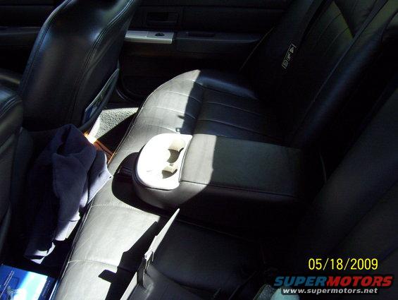 Black leather interior with cup holder and folded blue cloth