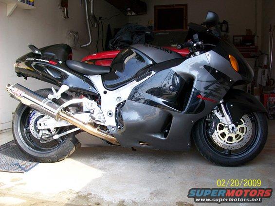 1999 Suzuki Hayabusa 1300 motorcycle parked in a garage, side view. Features a Yoshimura exhaust