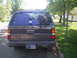 1993 Nissan Pathfinder - 1993 Nissan Pathfinder XE-V6 seen from the rear. The Indiana license plate reads 'GOD WE TRUST 8856'.