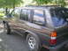 1993 Nissan Pathfinder - Side view of a 1993 Nissan Pathfinder SUV with a 'Pathfinder' decal on the rear window.
