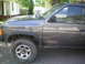 1993 Nissan Pathfinder - The side profile of a 1993 Nissan Pathfinder SUV is visible, parked in a residential area.