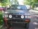 1993 Nissan Pathfinder - A dark gray 1993 Nissan Pathfinder is shown from the front, supported by a red jack.