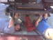 2008 Jeep Wrangler - Two people are working on the underside of a 2008 Jeep Wrangler lifted by a floor jack.