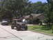 2008 Jeep Wrangler - Multiple Jeep Wranglers are gathered on a residential street and lawn, with one undergoing maintenance.