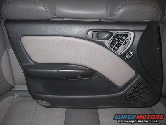 Gray and black car door panel with power window controls