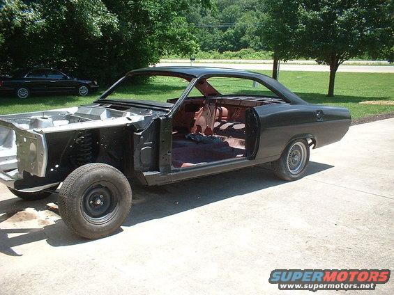 Body work DONE and in primer !!!!!!!!!!!  Will have vinyl top, headliner and front / rear glass installed and then Danny will paint.........hopefully in the next couple of weeks.....