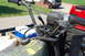 1985 Ford Ranger - The handlebars and front section of a utilitarian three-wheeled vehicle are shown, with other vehicles in the background.